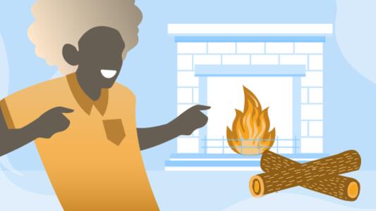 Person, die vor dem brennenden Kamin steht